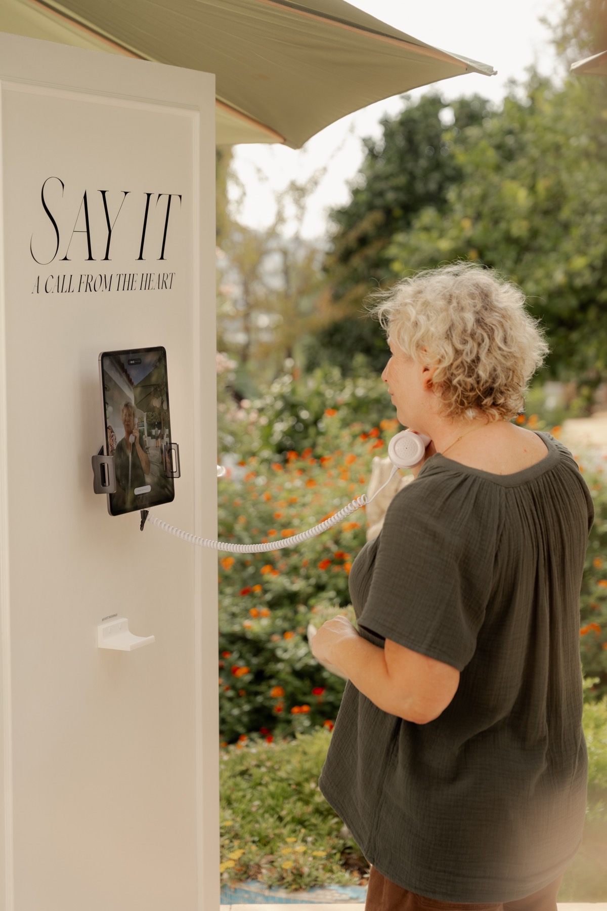 An older guest leaving a message on the Say It phone